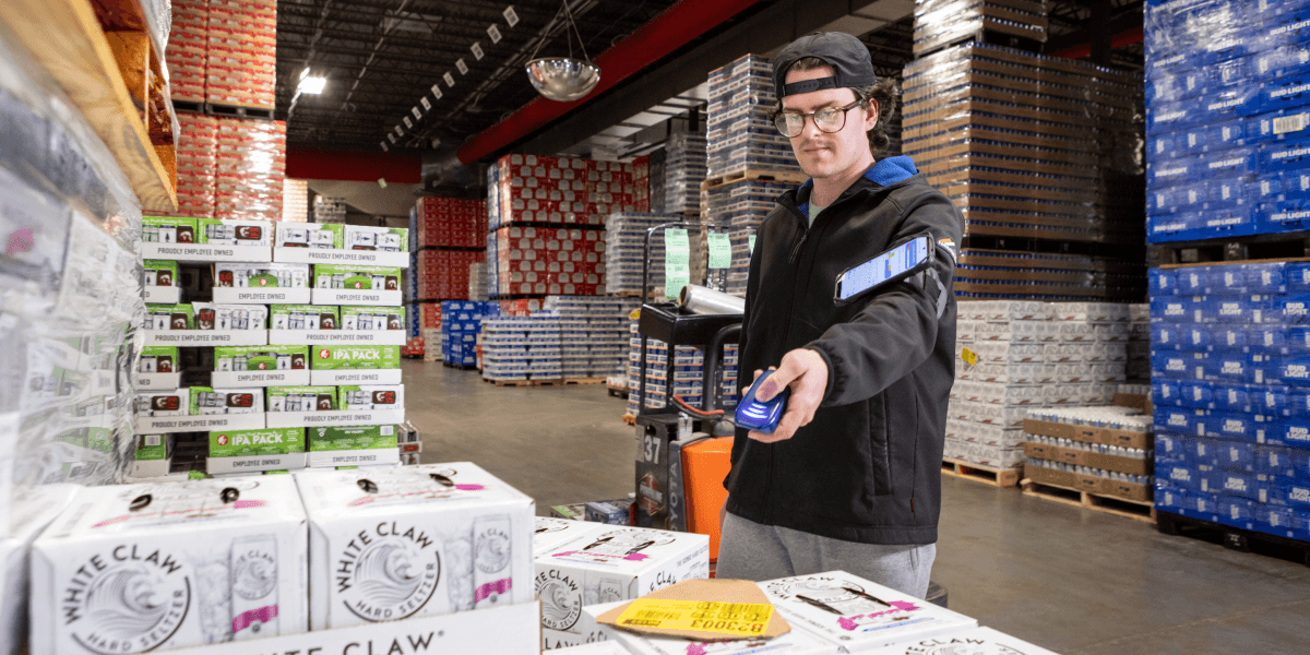 man in beverage warehouse picking scanning inventory