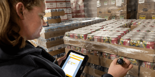 woman in a warehouse checking inventory
